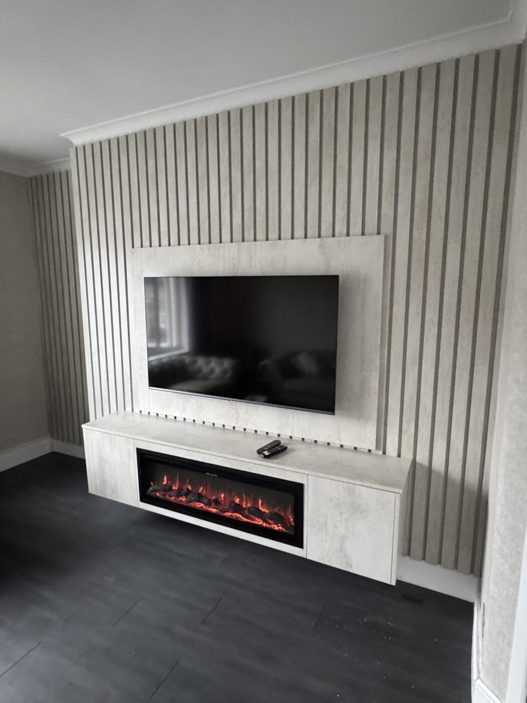 Bespoke slatted media wall with fireplace